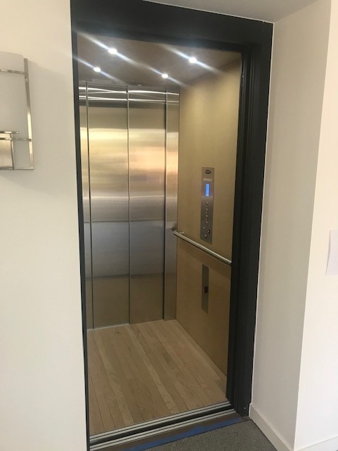 In-Home Black Metal Glass Door Elevator Installed in Central CA with silver finishes
